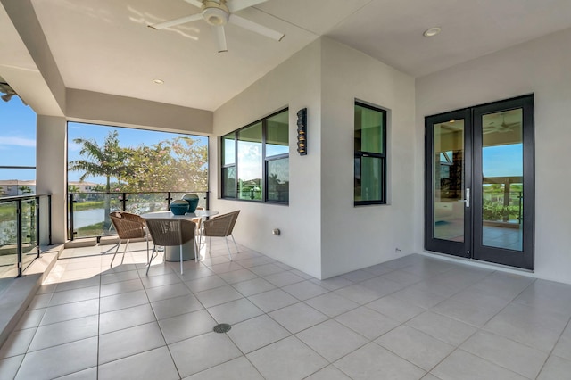 view of patio / terrace featuring ceiling fan and a water view