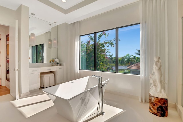 bathroom featuring vanity and a tub to relax in