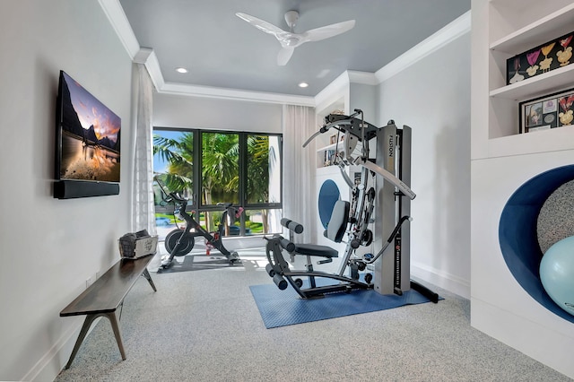 workout area featuring ceiling fan, ornamental molding, and built in features