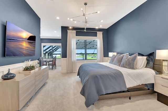 bedroom featuring an inviting chandelier and light colored carpet