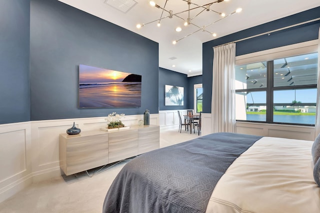 carpeted bedroom featuring a water view