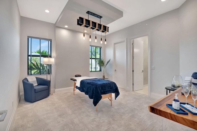 bedroom featuring light parquet flooring and ensuite bath