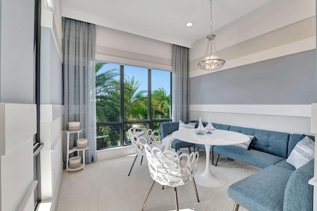 carpeted dining room with breakfast area and plenty of natural light