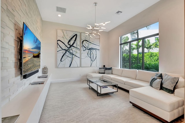 living room featuring a chandelier and carpet