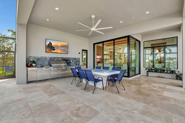 view of patio featuring ceiling fan, an outdoor kitchen, and grilling area