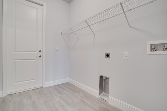 laundry room featuring hookup for an electric dryer, light hardwood / wood-style flooring, and hookup for a washing machine