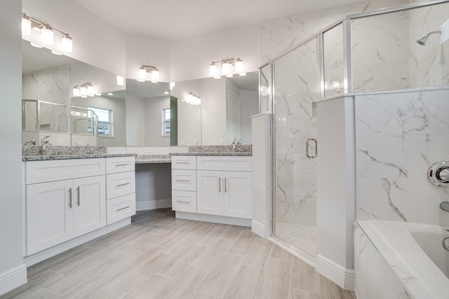 bathroom with shower with separate bathtub and vanity