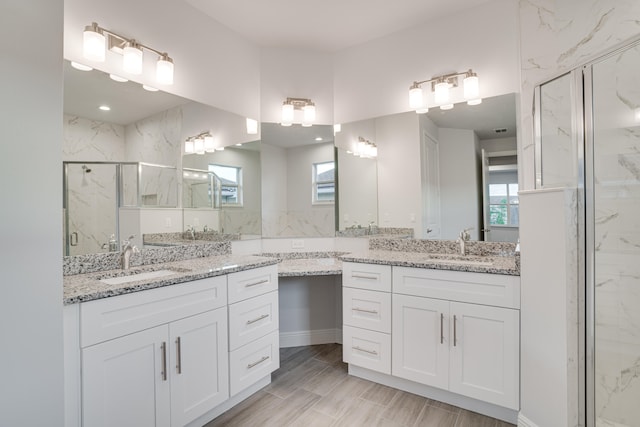 bathroom featuring an enclosed shower and vanity