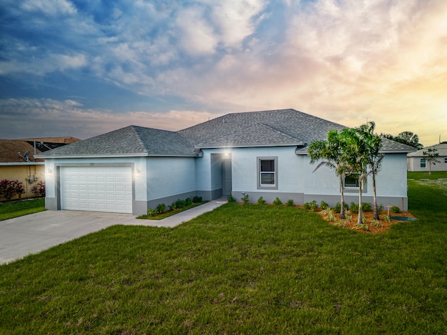 view of front of property featuring a garage and a yard