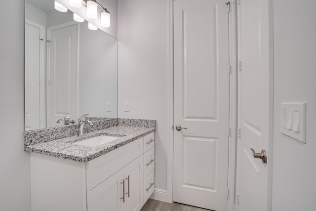 bathroom featuring vanity and hardwood / wood-style floors