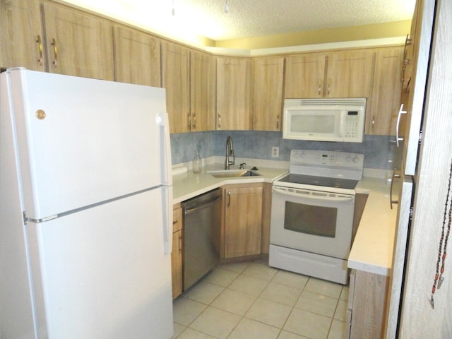 kitchen featuring white appliances, sink, a textured ceiling, tasteful backsplash, and light tile patterned flooring