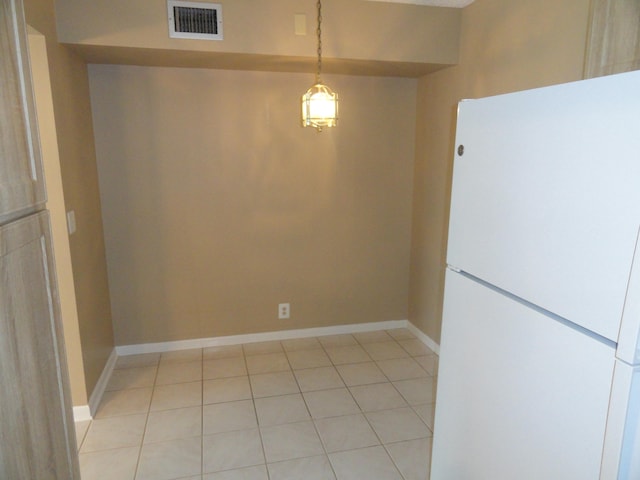 unfurnished dining area with light tile patterned floors