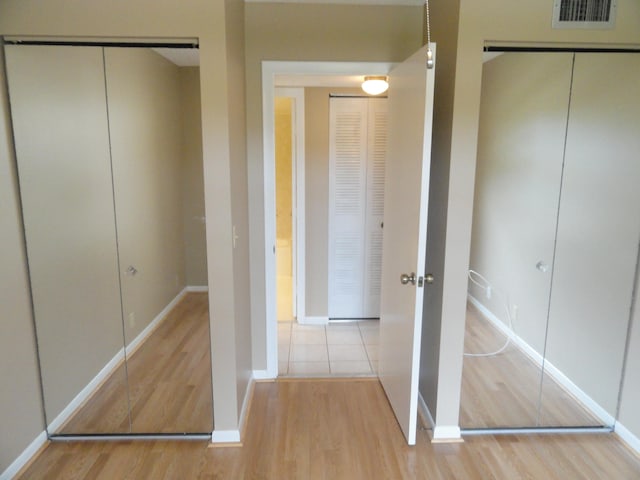 hallway with light hardwood / wood-style floors