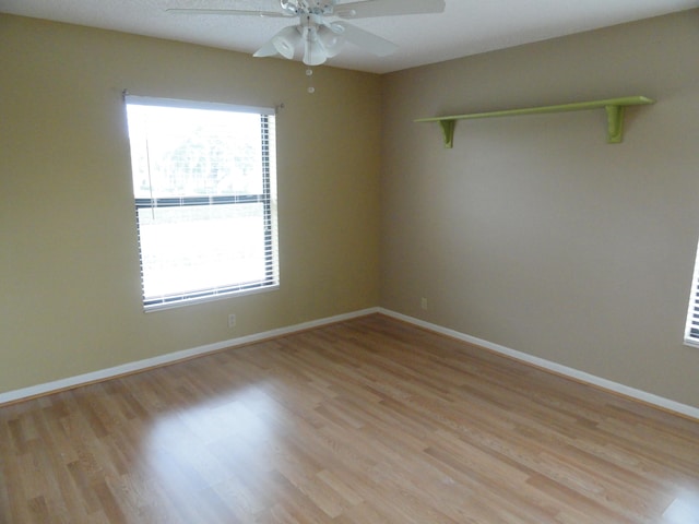 empty room with light wood-type flooring and ceiling fan