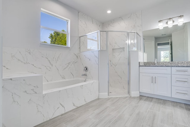 bathroom with vanity and plus walk in shower