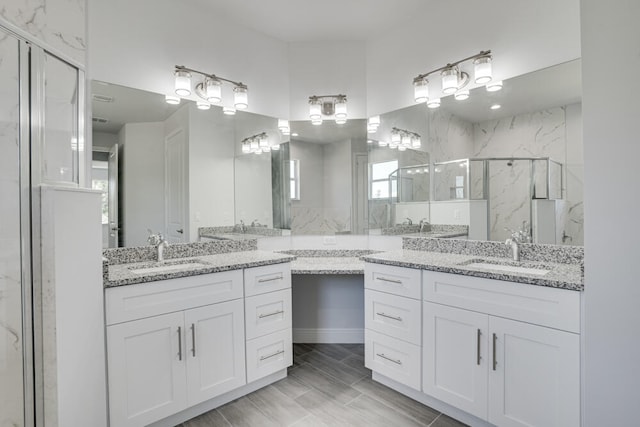 bathroom featuring vanity and a shower with door