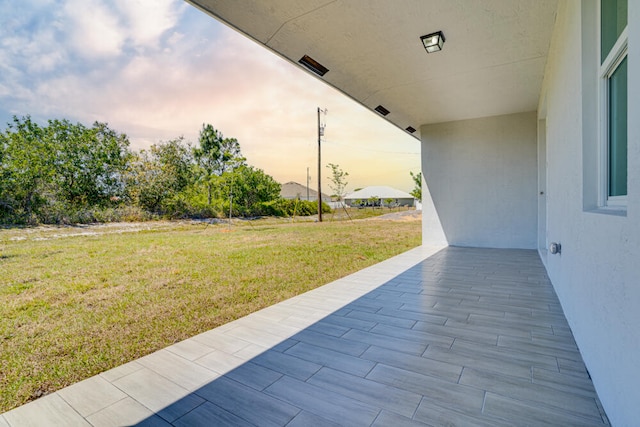 patio terrace at dusk with a yard