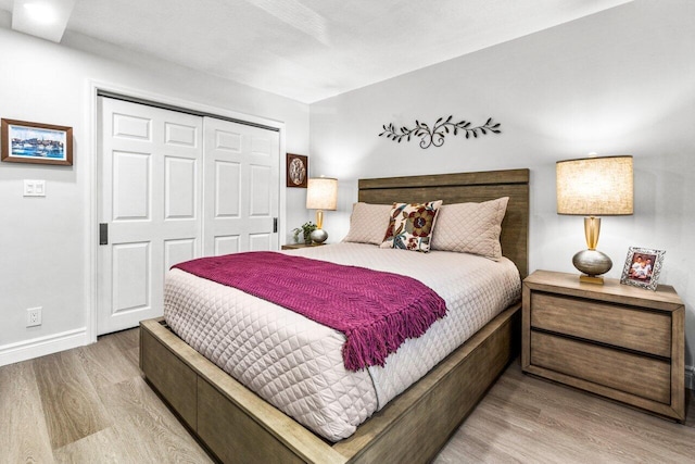 12871 Briarlake Dr Unit 102, Palm Beach Gardens, FL 33418 - bedroom with wood finished floors, a closet, and baseboards