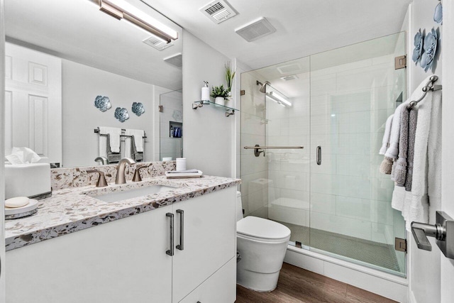 12871 Briarlake Dr Unit 102, Palm Beach Gardens, FL 33418 - bathroom featuring wood finished floors, a shower stall, toilet, and vanity