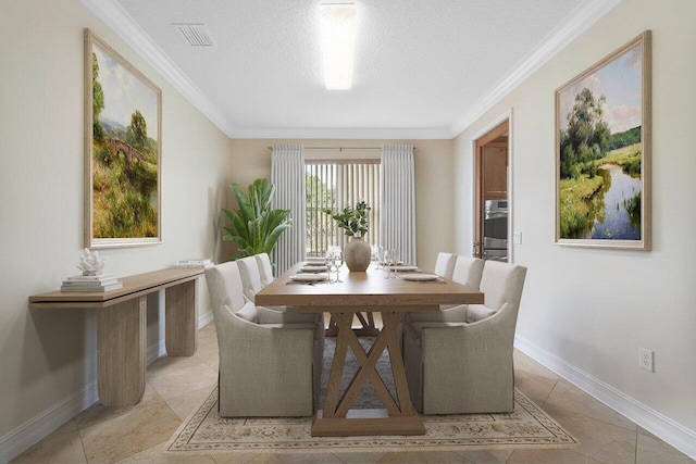 dining room with a textured ceiling and ornamental molding