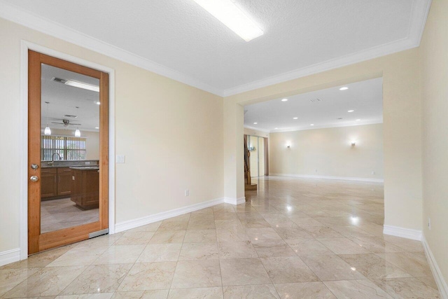 spare room with crown molding, sink, and a textured ceiling