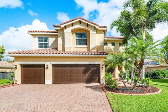 mediterranean / spanish house with a garage