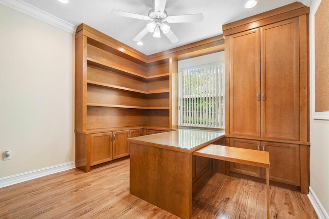 unfurnished office with a textured ceiling, light hardwood / wood-style flooring, and ornamental molding