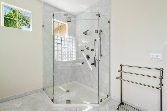 bathroom featuring a shower with shower door