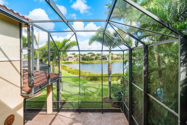 unfurnished sunroom with a water view