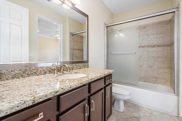 full bathroom with tile patterned floors, vanity, toilet, and enclosed tub / shower combo