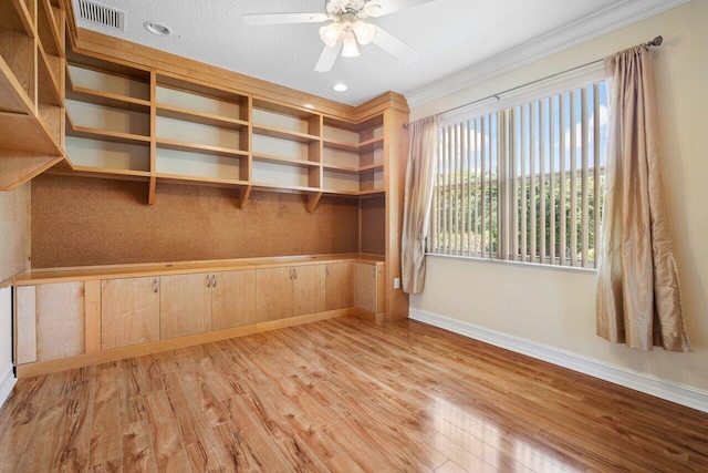 unfurnished room with a textured ceiling, light hardwood / wood-style floors, ceiling fan, and crown molding