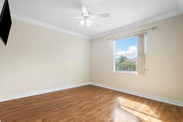 spare room with ornamental molding, a textured ceiling, and hardwood / wood-style flooring