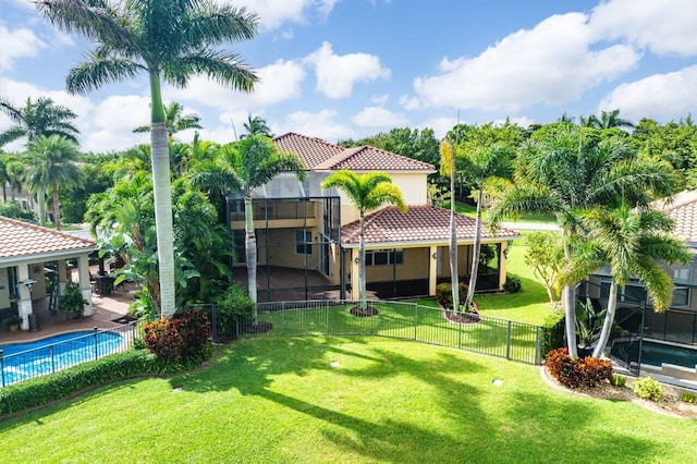 view of yard with a fenced in pool and glass enclosure