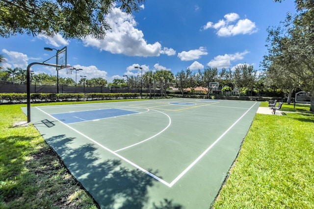 view of basketball court with a yard