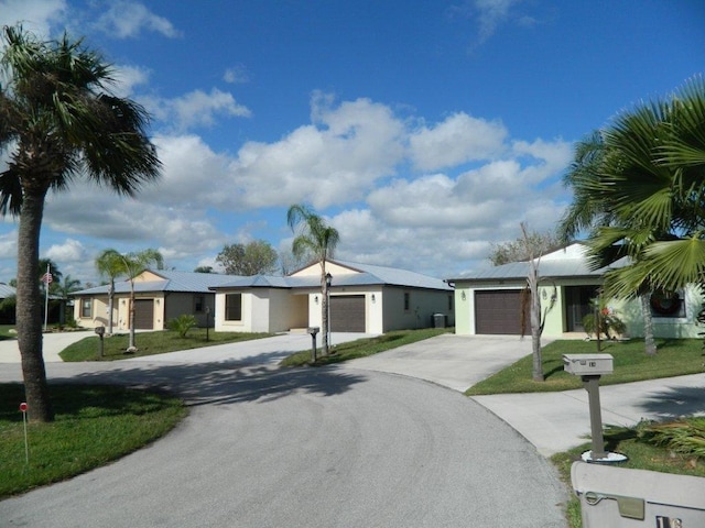 single story home with a garage and a front lawn