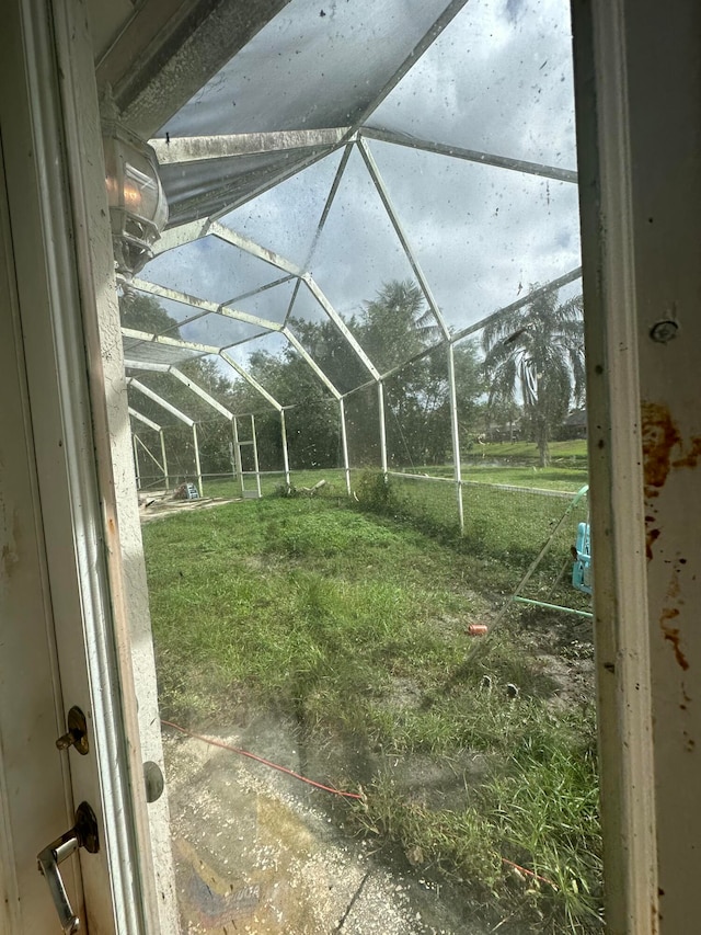 view of yard with glass enclosure