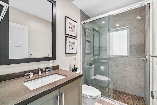 bathroom featuring vanity, toilet, and an enclosed shower