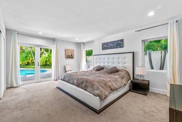 bedroom featuring access to exterior, french doors, and light colored carpet