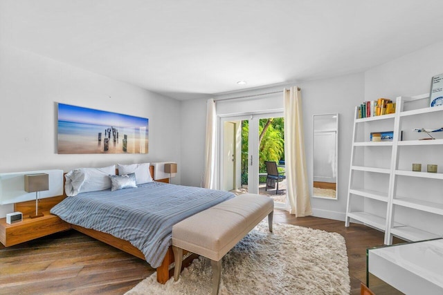 bedroom featuring access to outside and dark hardwood / wood-style floors