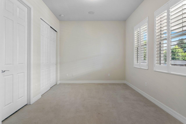 unfurnished bedroom with light colored carpet