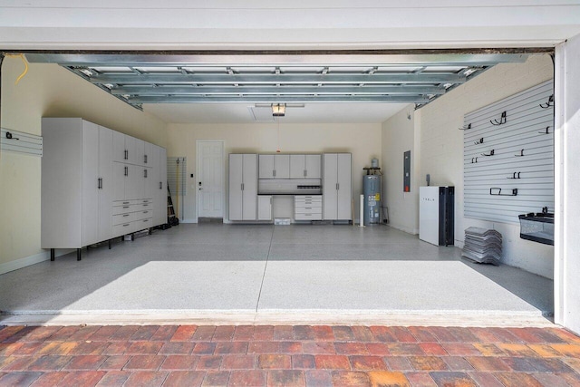 garage featuring electric water heater and electric panel