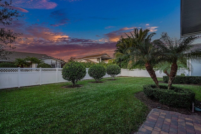 view of yard at dusk