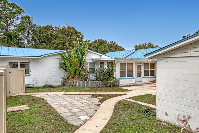 rear view of house with a lawn