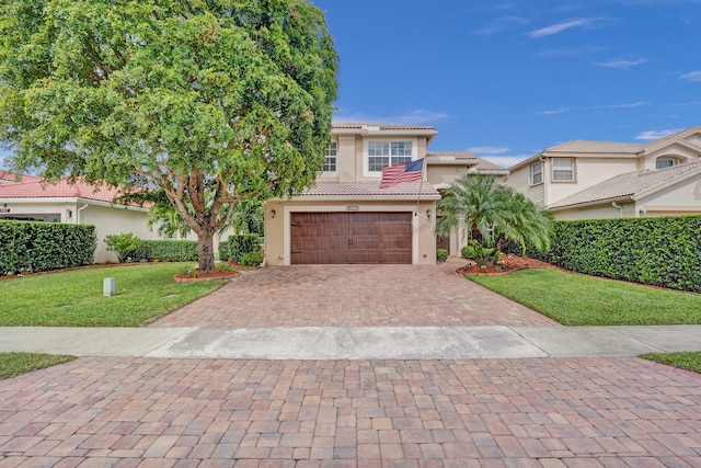 mediterranean / spanish-style house featuring a front lawn and a garage