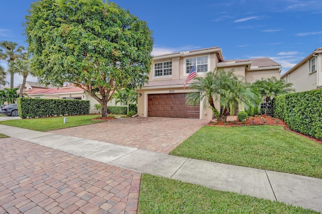 view of front facade with a front yard and a garage