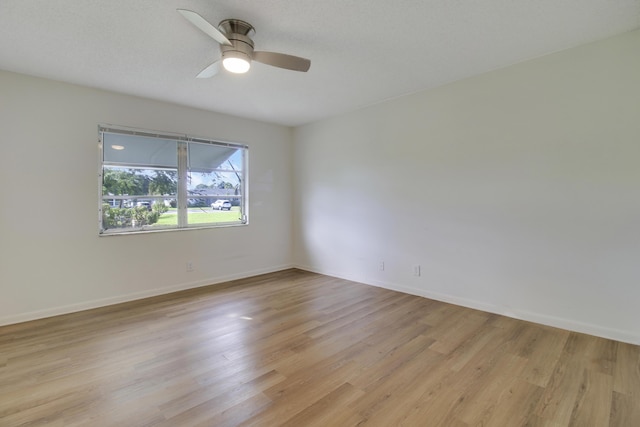 spare room featuring ceiling fan and light wood-type flooring