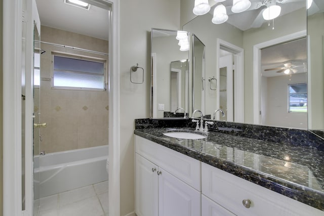 full bathroom featuring ceiling fan, tiled shower / bath combo, tile patterned floors, toilet, and vanity