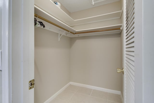 walk in closet featuring light tile patterned flooring