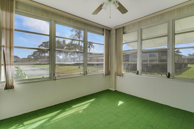 unfurnished sunroom featuring ceiling fan