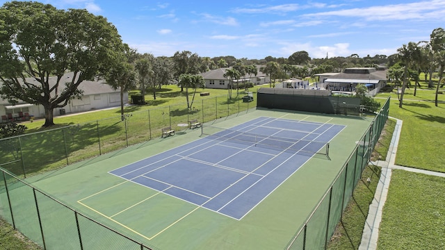 view of sport court with a lawn